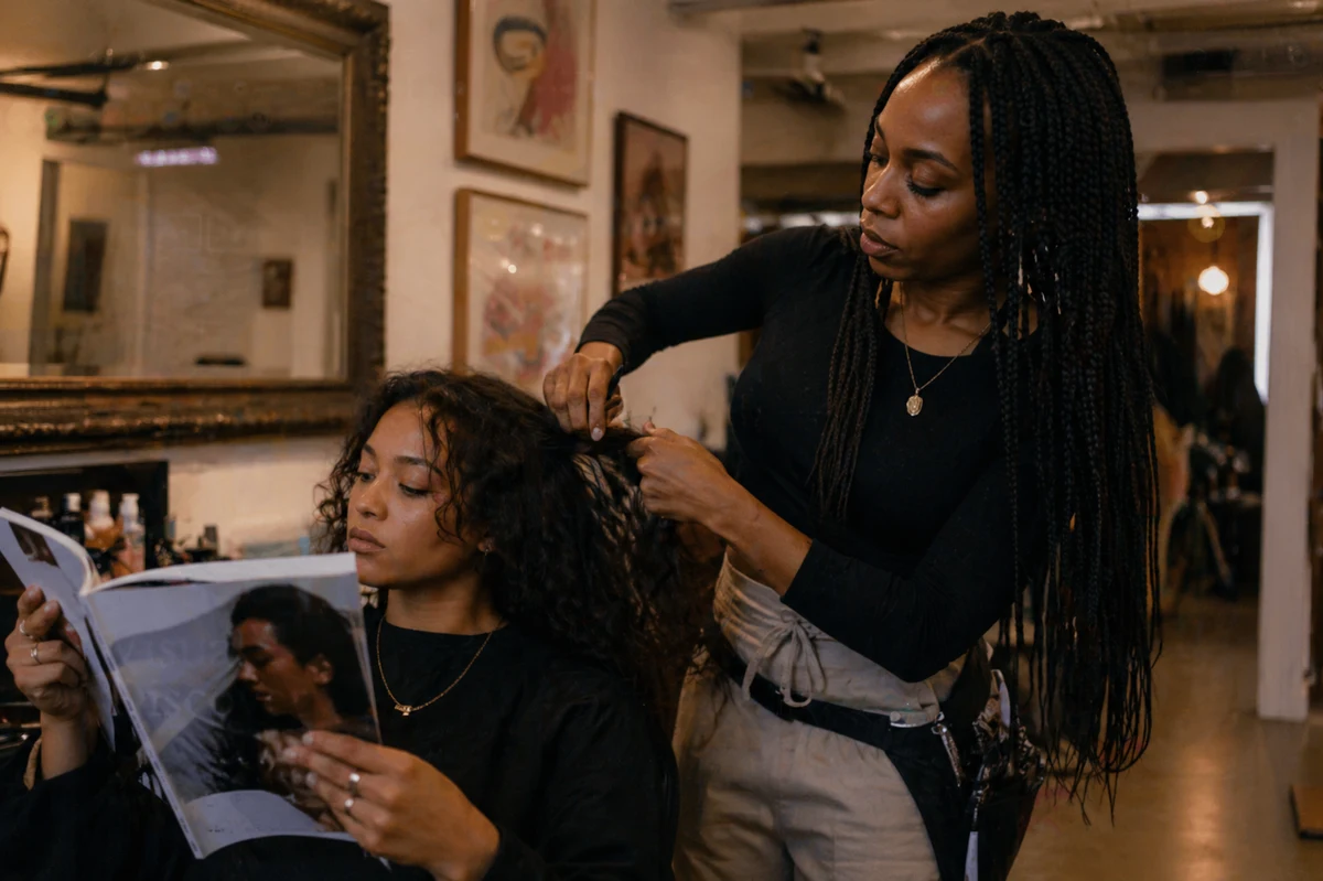 A stylist working carefully on a client’s hair